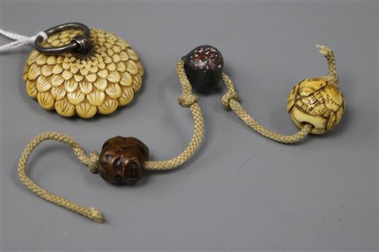 A Japanese ivory manju netsuke of a flower and three various ojime, 19th century